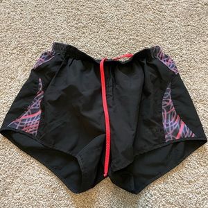 Black ASICS shorts with pink and purple pattern with panty liner and drawstring